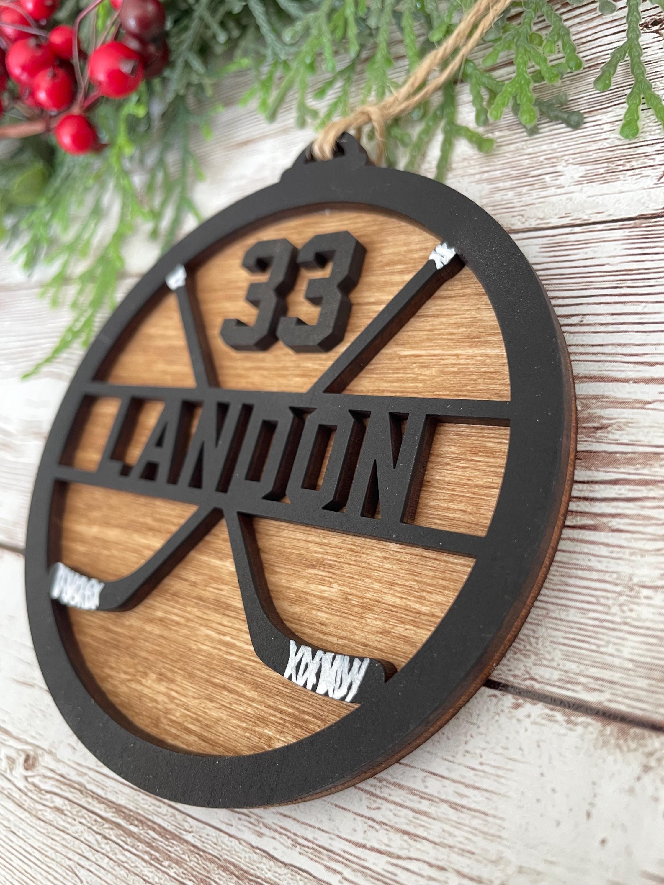 Hockey personalized ornament wood handmade black paint wood stained background twine string to hand sticks hockey team coach manager gift